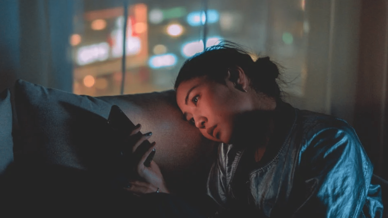 A woman looking sad while texting