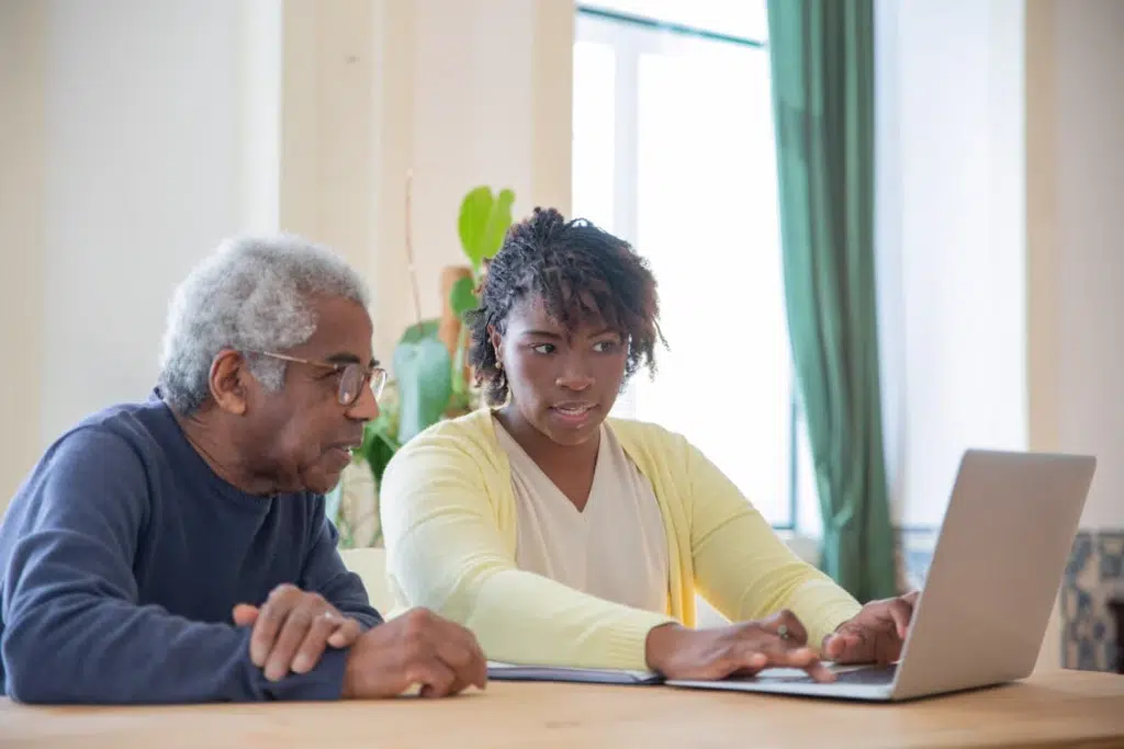 A man and a woman using a laptop