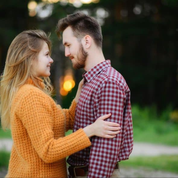 A man and woman facing each other