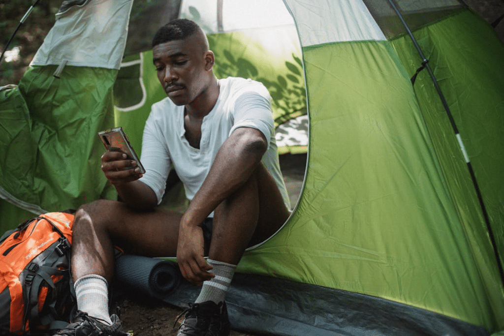 A man in a green tent