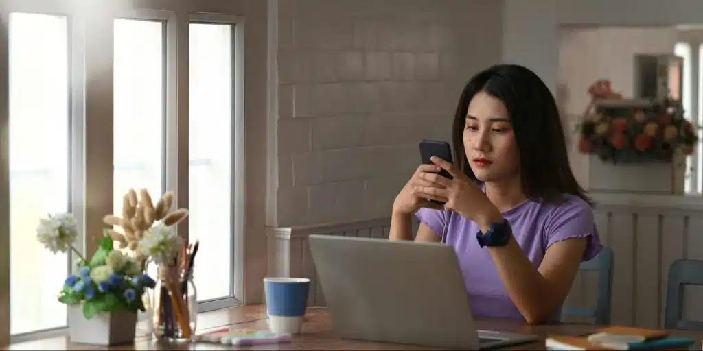 A woman seriously using a phone