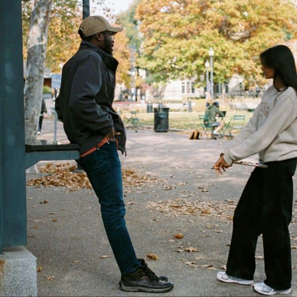 A man and woman talking outside