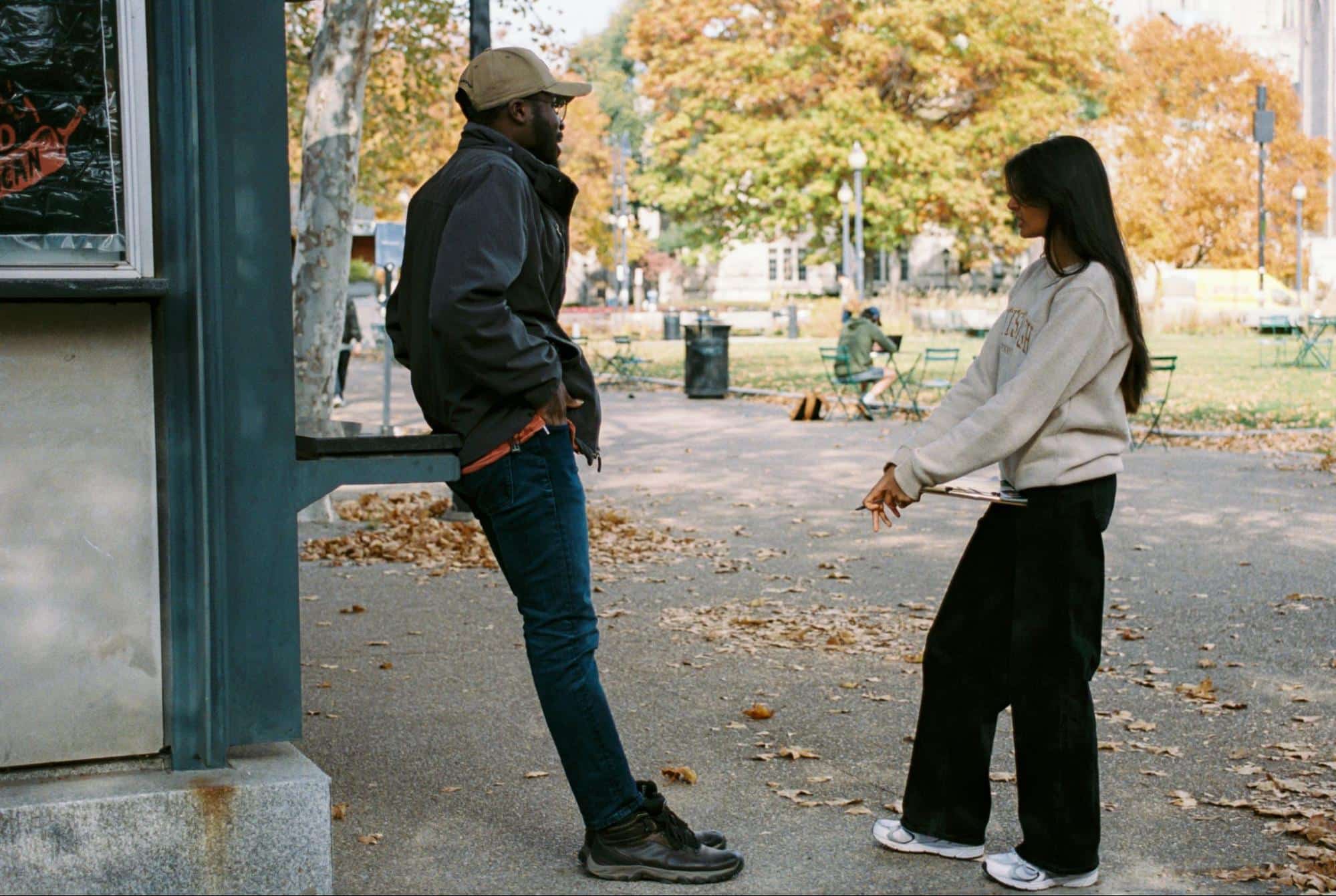 A man and woman talking outside