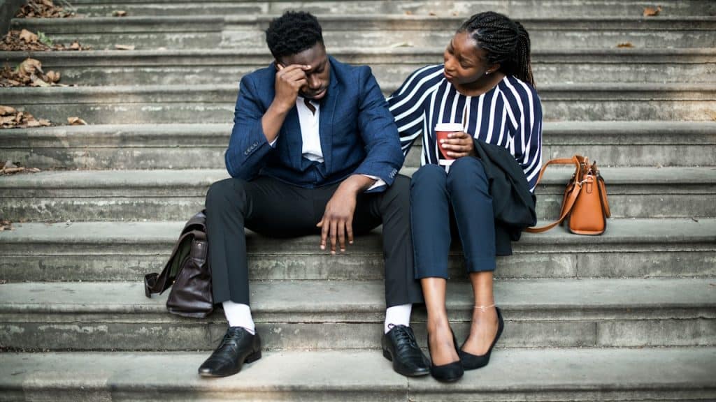 Woman consoling her worried boyfriend.