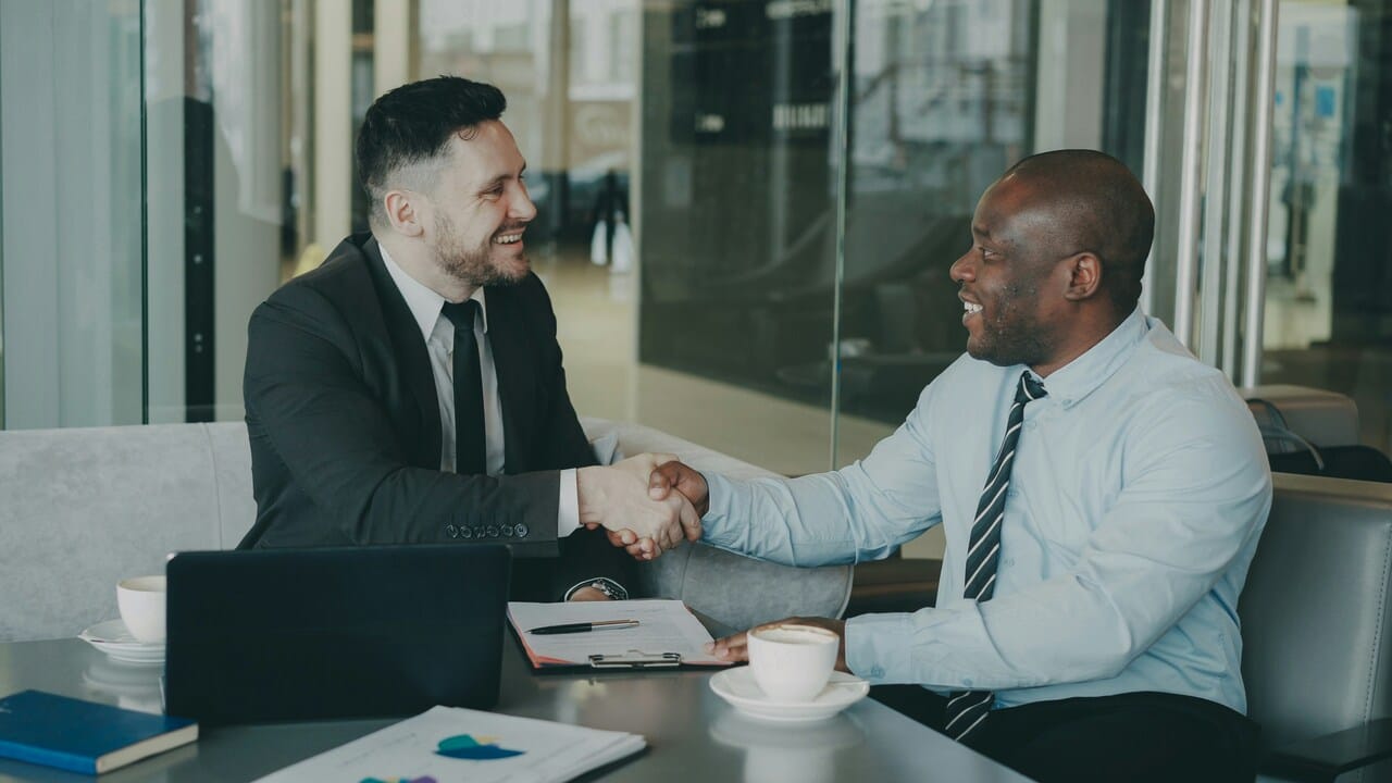 Colleagues shaking hands in the office