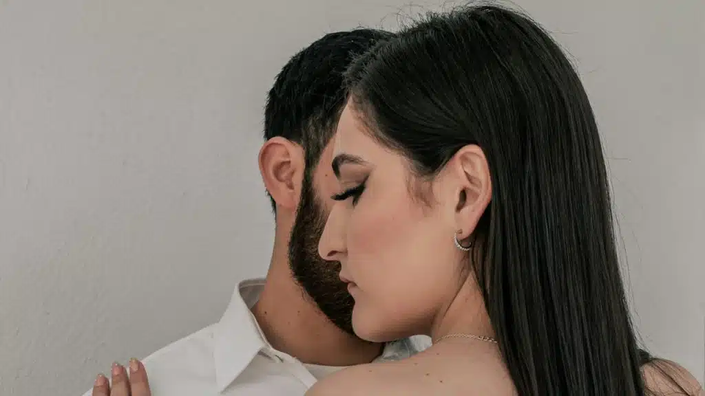 A man and a woman embracing each other.