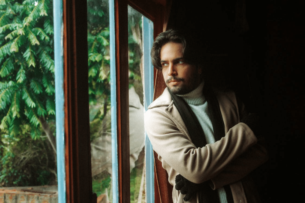 Contemplative Man by the Window on a Cloudy Day