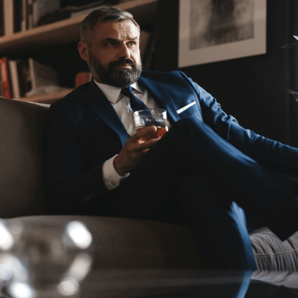 A handsome mature man drinking whiskey