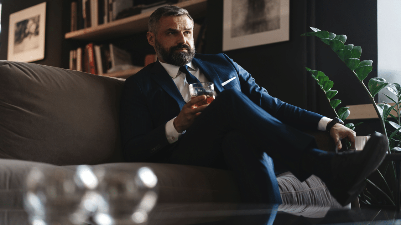 A handsome mature man drinking whiskey