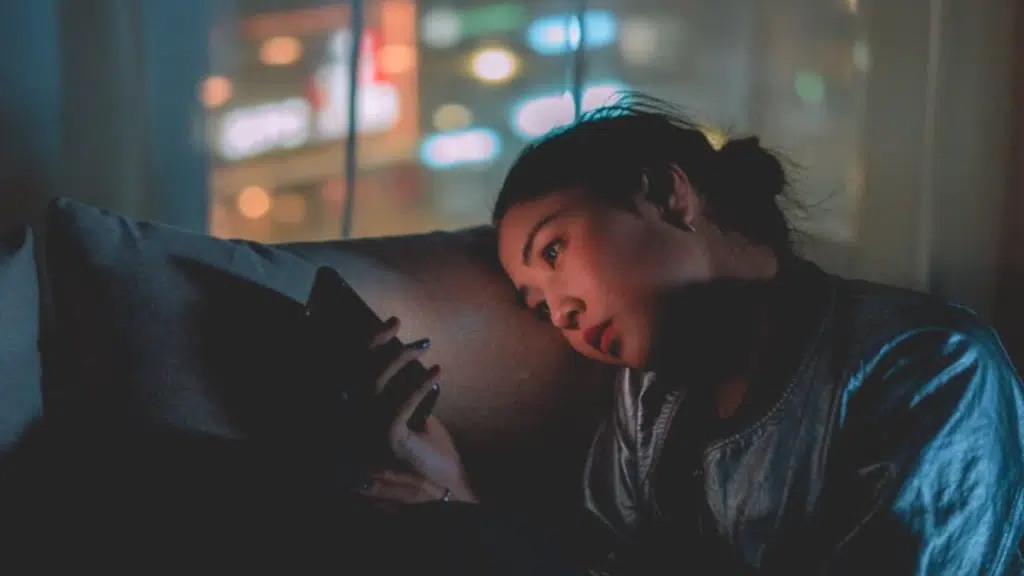 A woman looking sad while texting