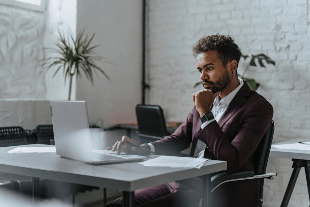 A man in a suit using a laptop