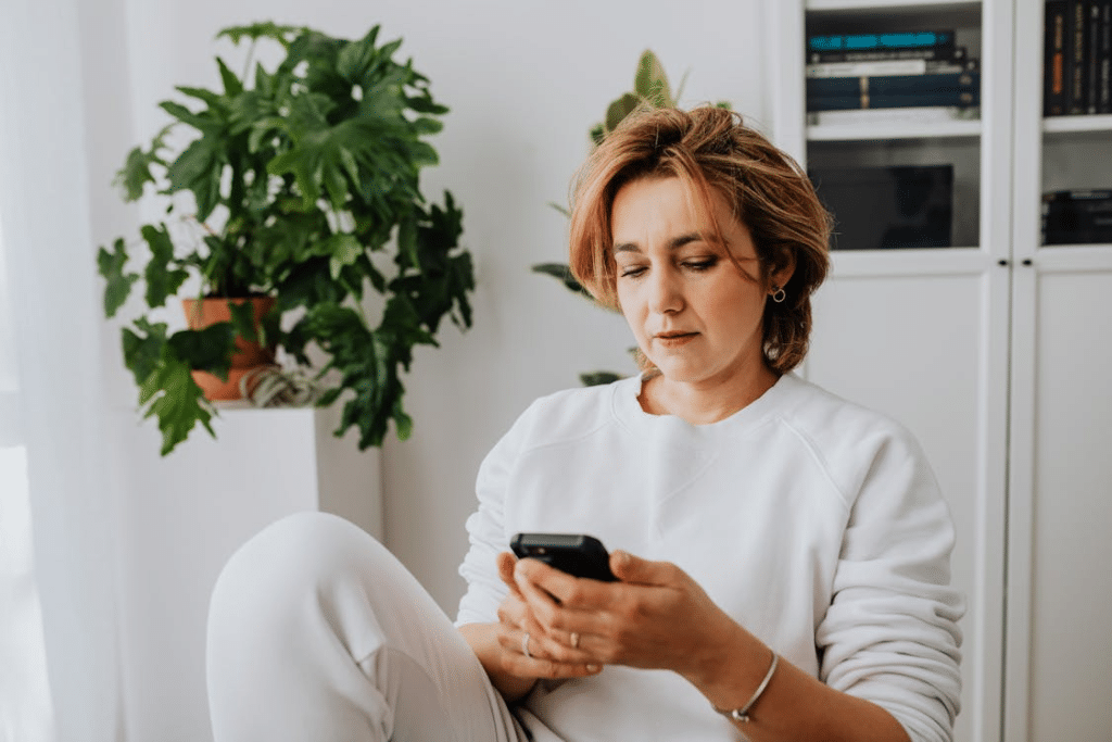 A woman in white using a phone