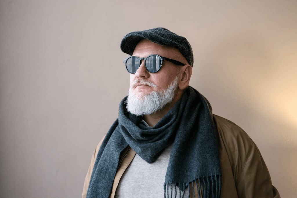 A man wearing a scarf and sunglasses