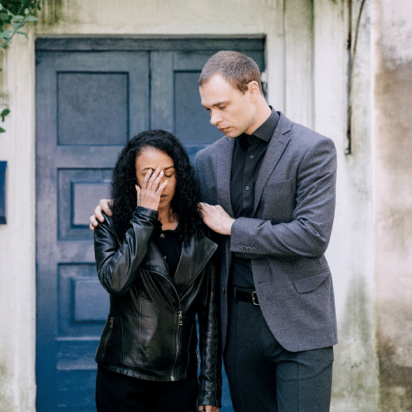 A Man Comforting a Woman in Black Leather Jacket