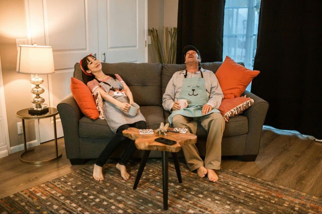 A man and woman sitting at the sofa