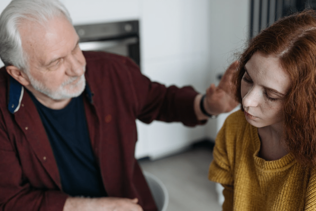 An older man comforting a younger woman