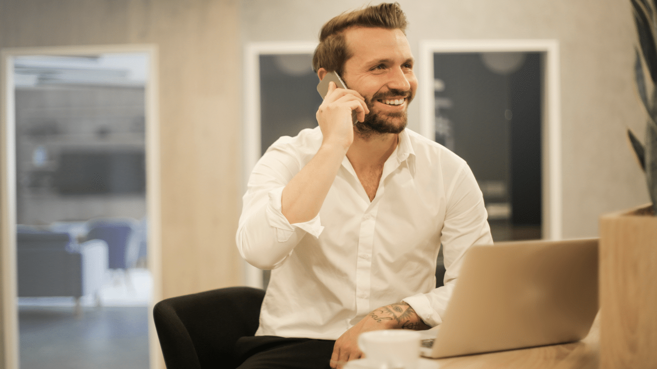 A man on the phone while in the office 
