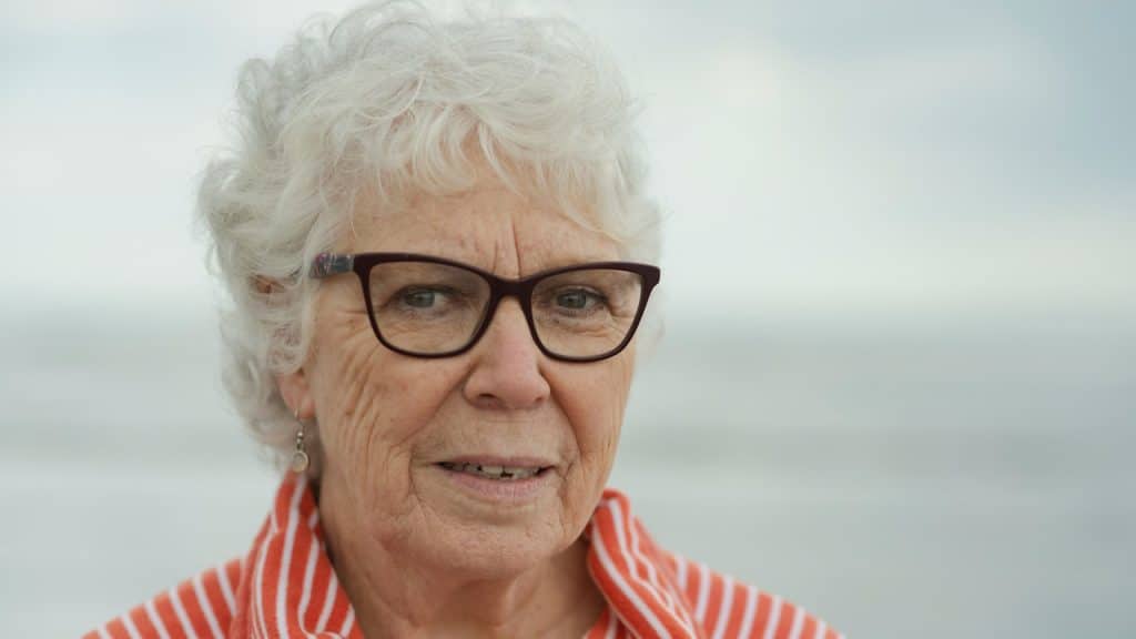 An older woman wearing glasses.