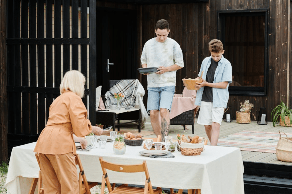 Mother and sons preparing table