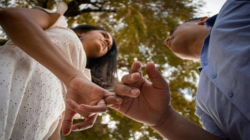 A couple doing the pinky swear