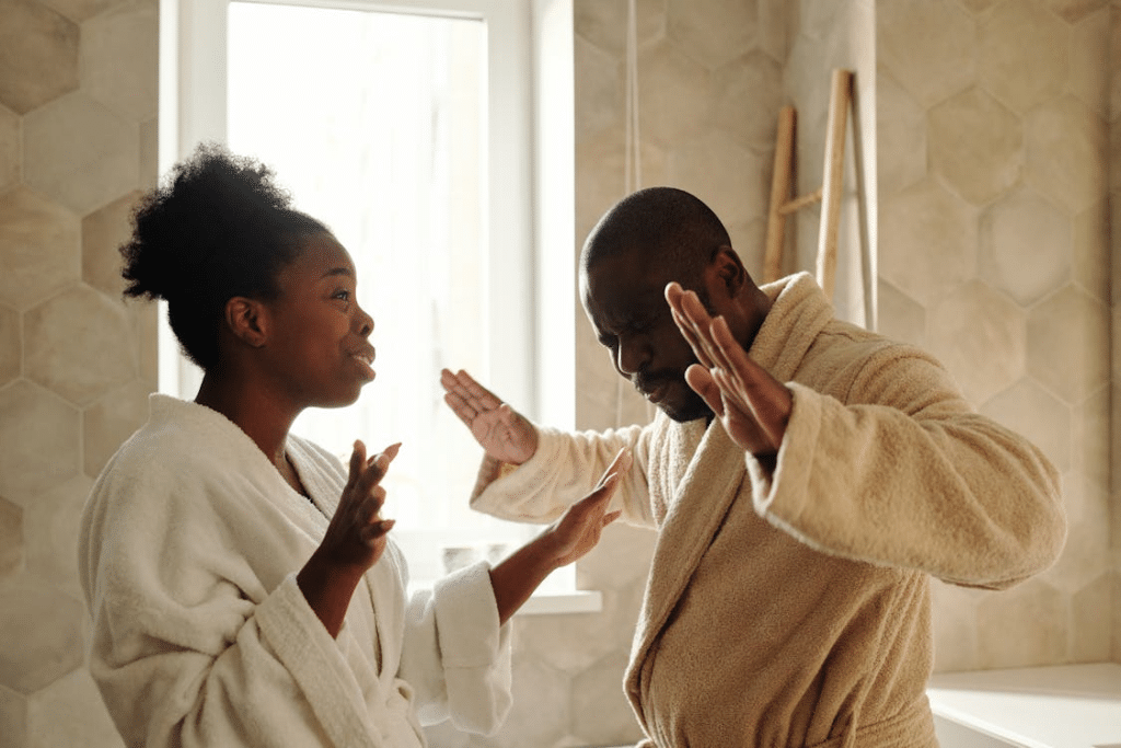 Couple Wearing Bathrobes Talking Inside the Bathroom