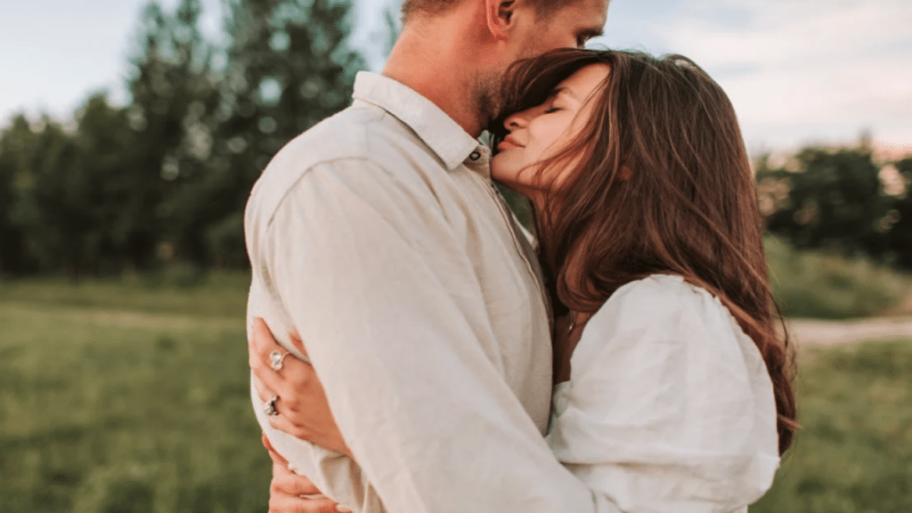 A couple hugging outdoors