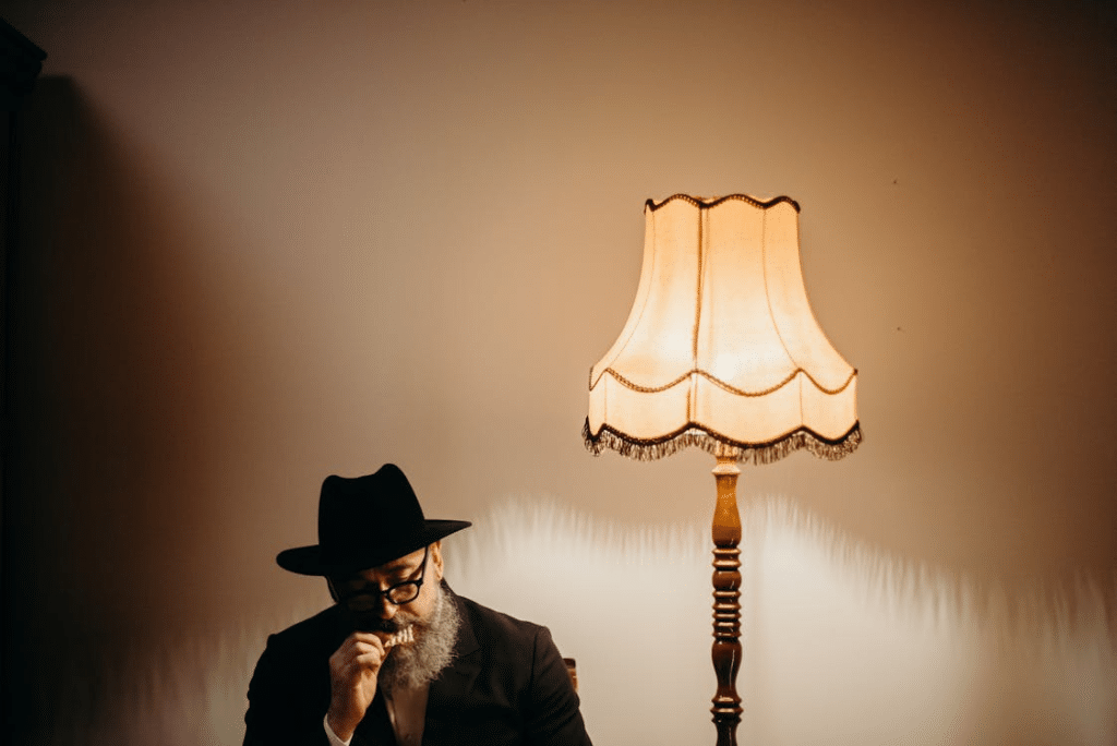 Photo Of Man Eating Beside Lamp