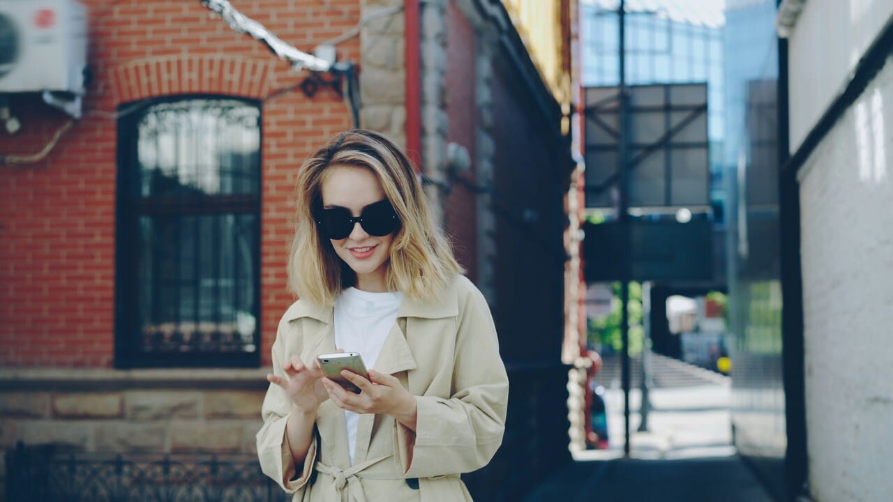 A woman texting outdoors