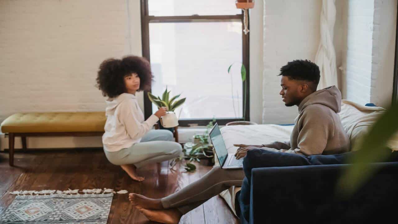 A couple doing their own thing at home