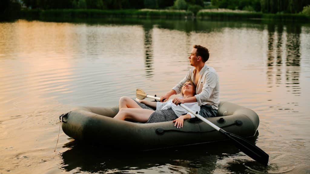 A man and a woman on a raft in the water.
