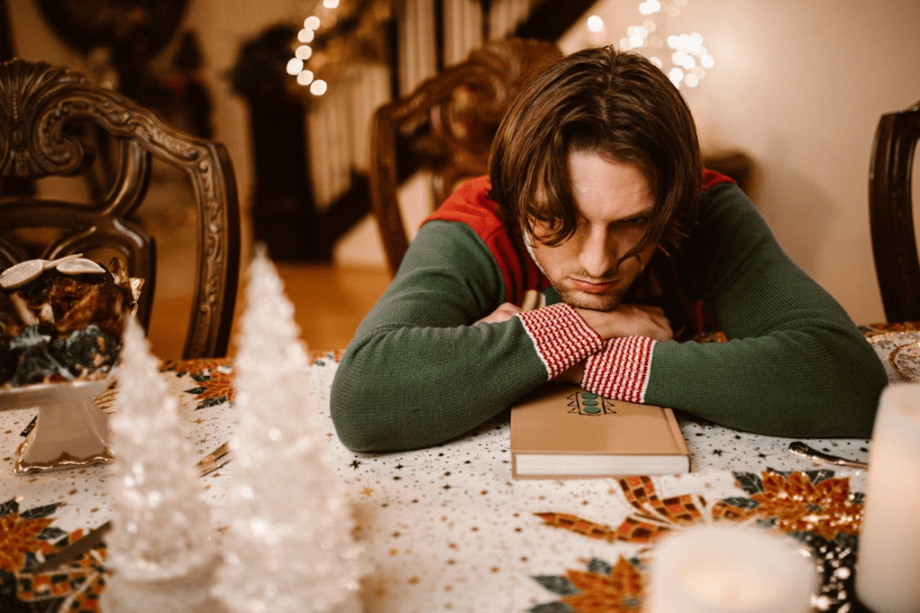 A Man in Green Sweater Lying on the Table