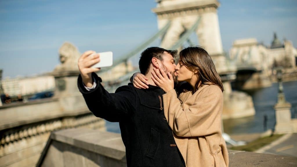 A lovely couple capturing a moment of kissing each other.