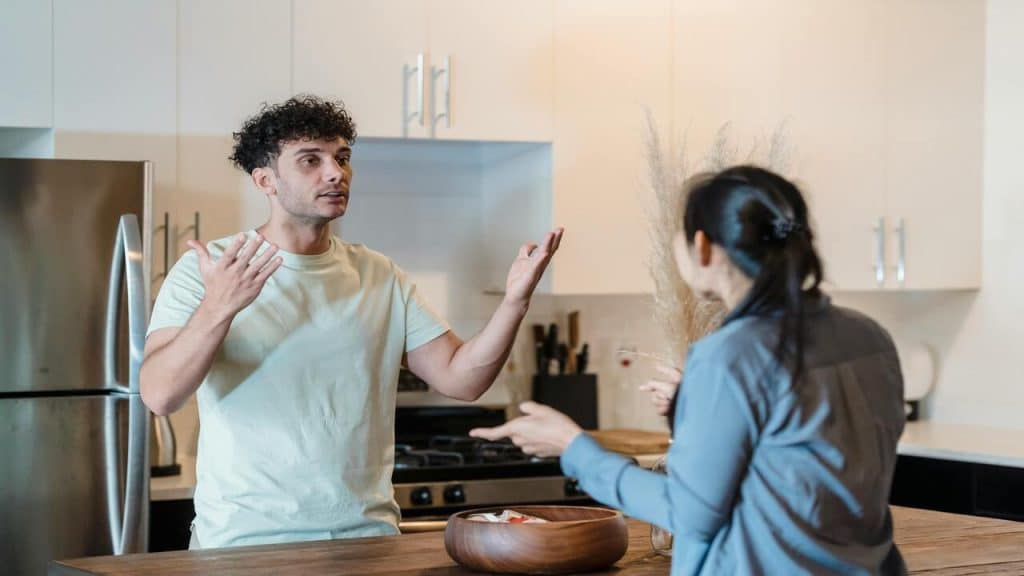 A couple arguing in the kitchen