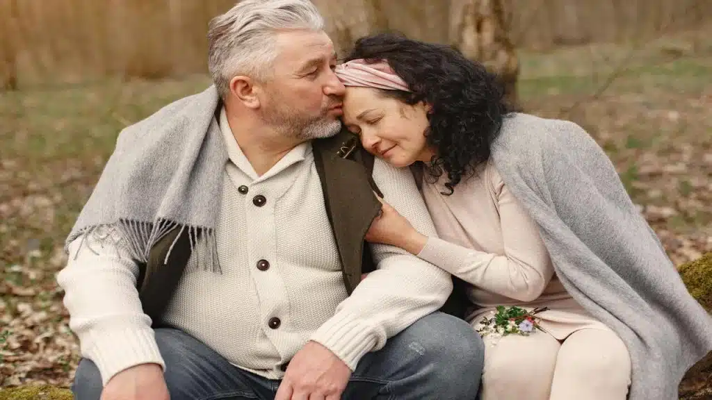 A man giving his girlfriend a forehead kiss 