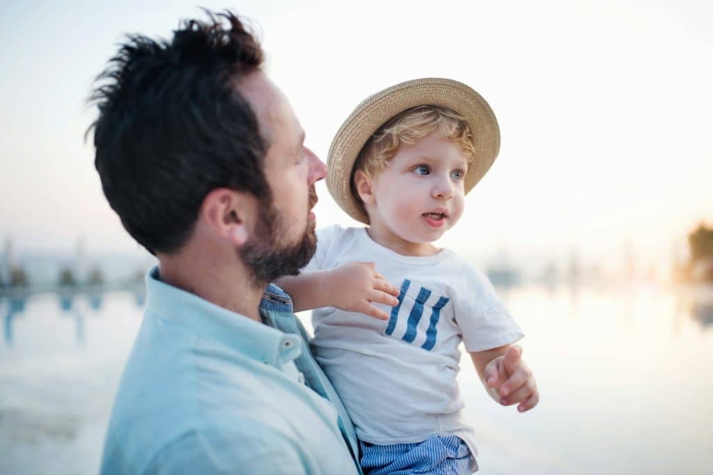 A mature father holding his son.
