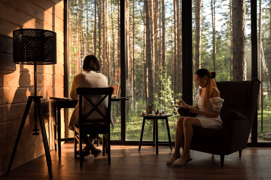 Couple sitting in living room with view on forest