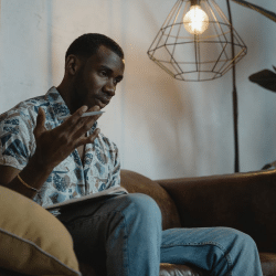 Man Sitting on Brown Leather Sofa While Thinking