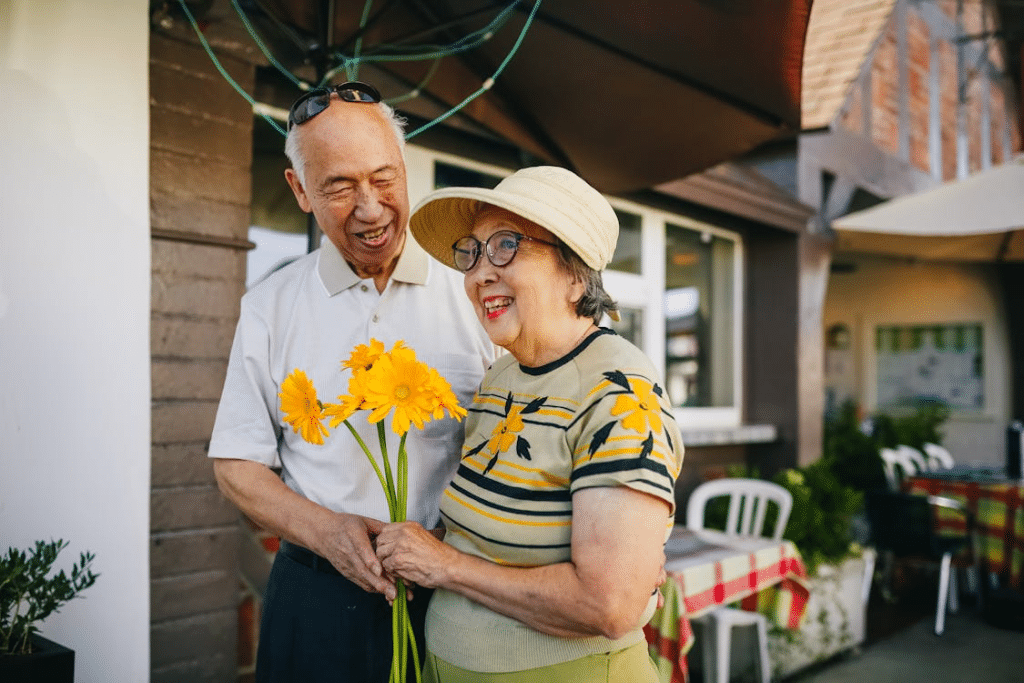 An older woman holding flowers