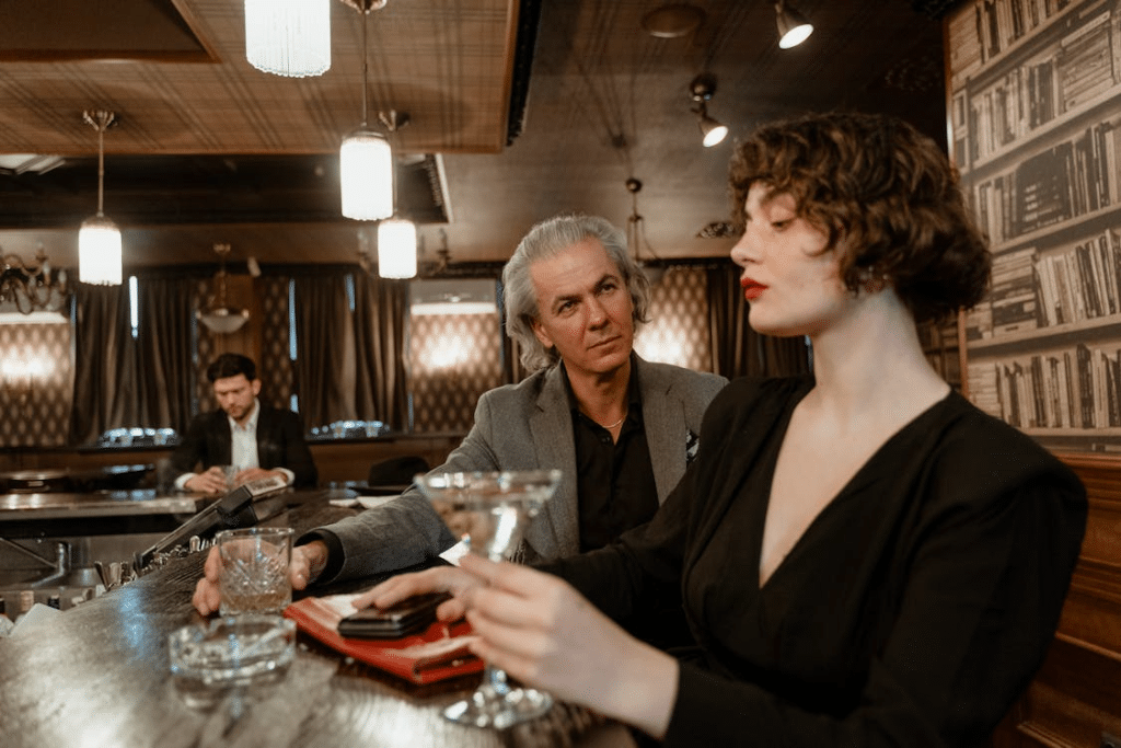 A man and woman sitting at a bar