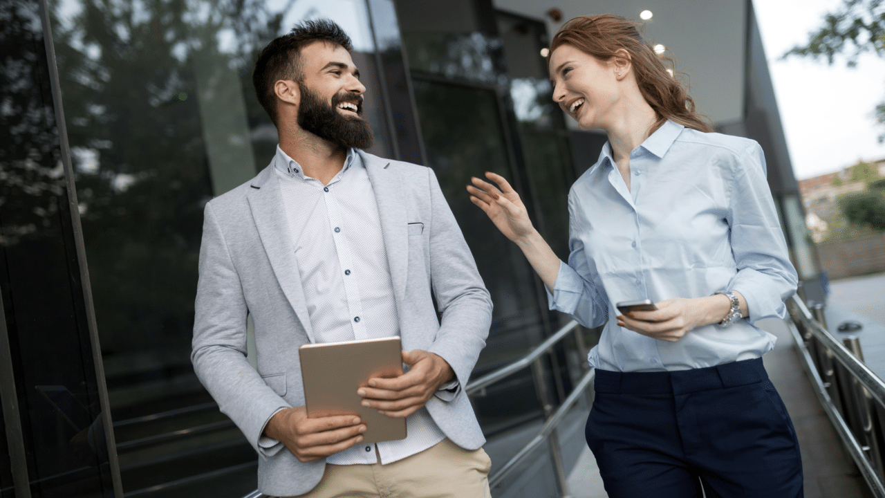 Colleagues laughing outside their home