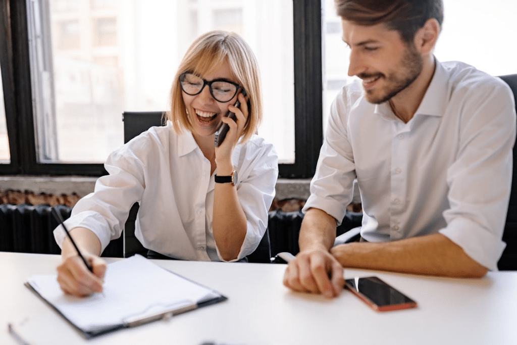 A woman taking notes while in a phone call