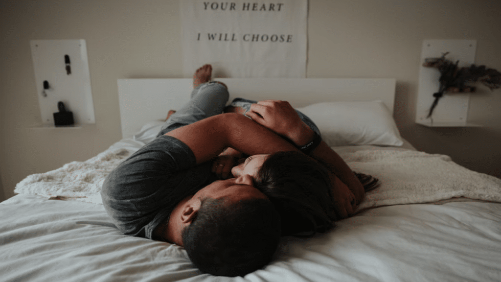 A couple cuddling in bed