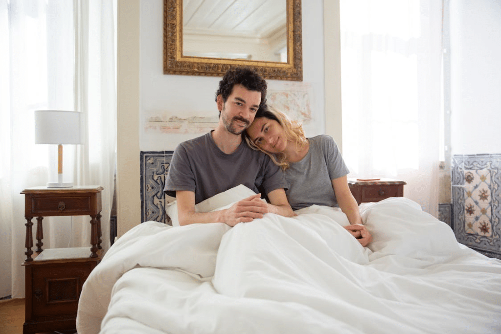 A couple sitting in the bed