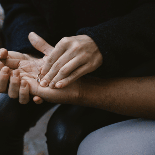 A woman giving her ring back to her husband