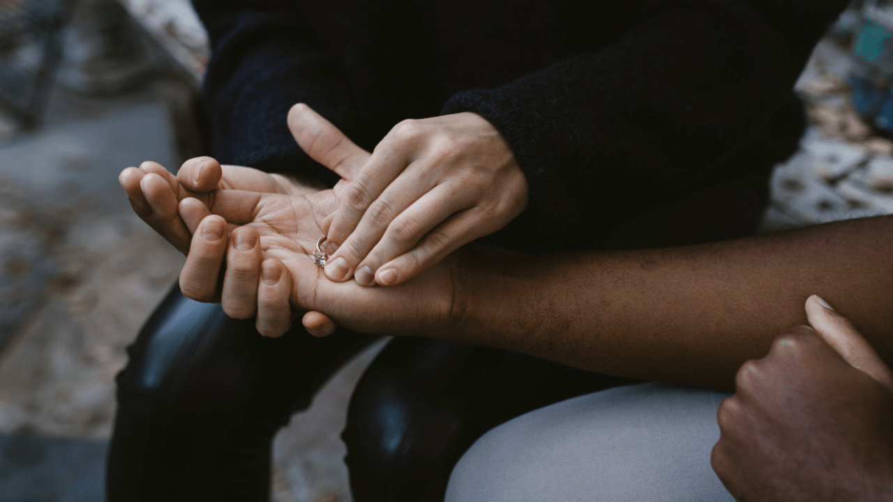 A woman giving her ring back to her husband