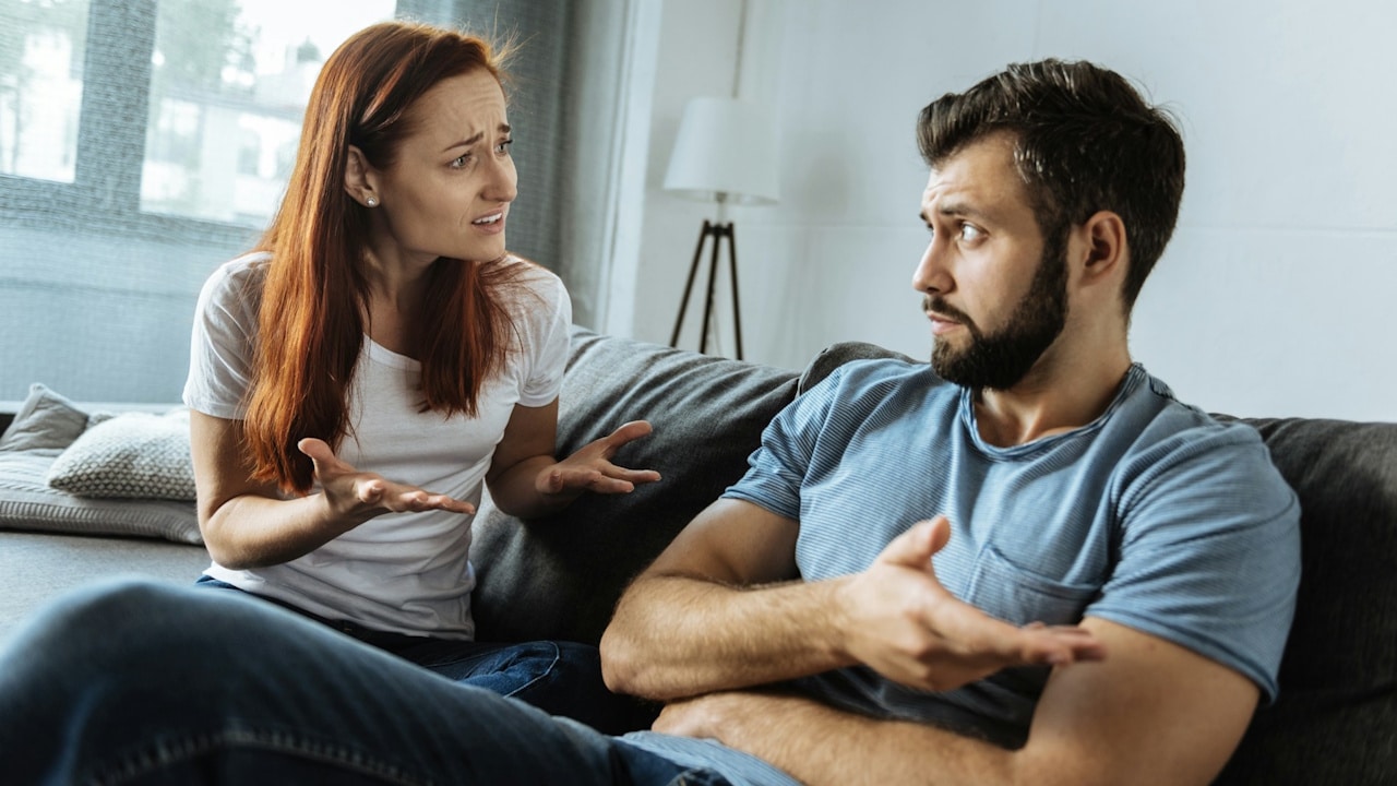A young woman complains to her husband while her husband is getting annoyed by it.