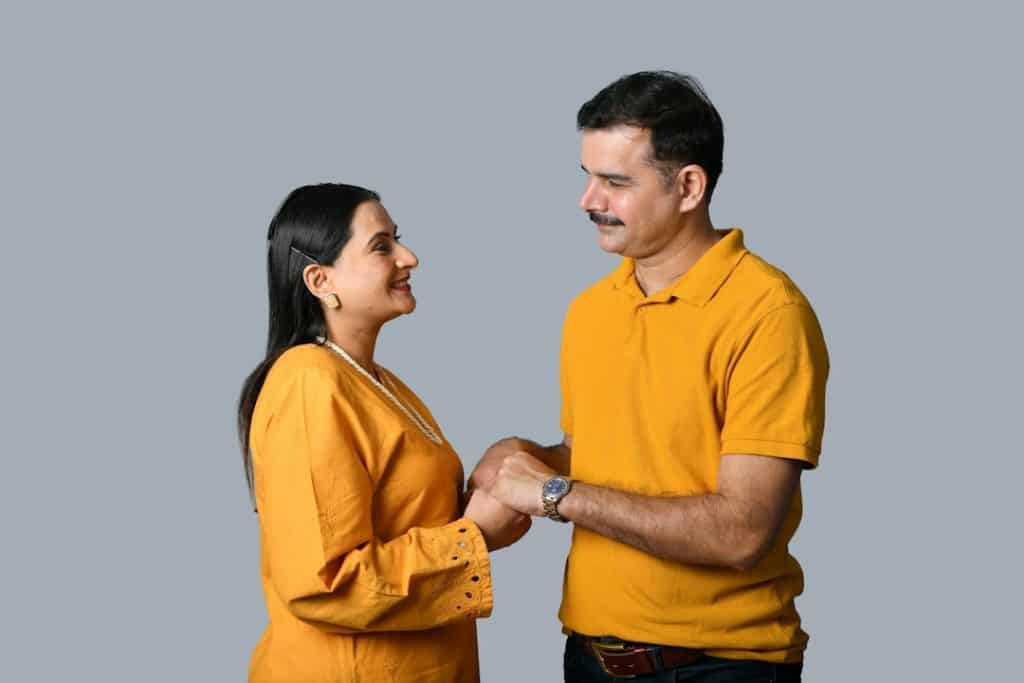 A man and a woman holding each others and looking at each other with love.