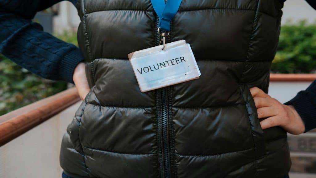 A person wearing a “volunteer” badge