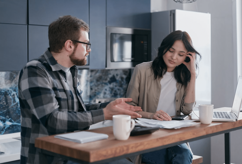 A Man Talking to a Woman with Documents on a Desk