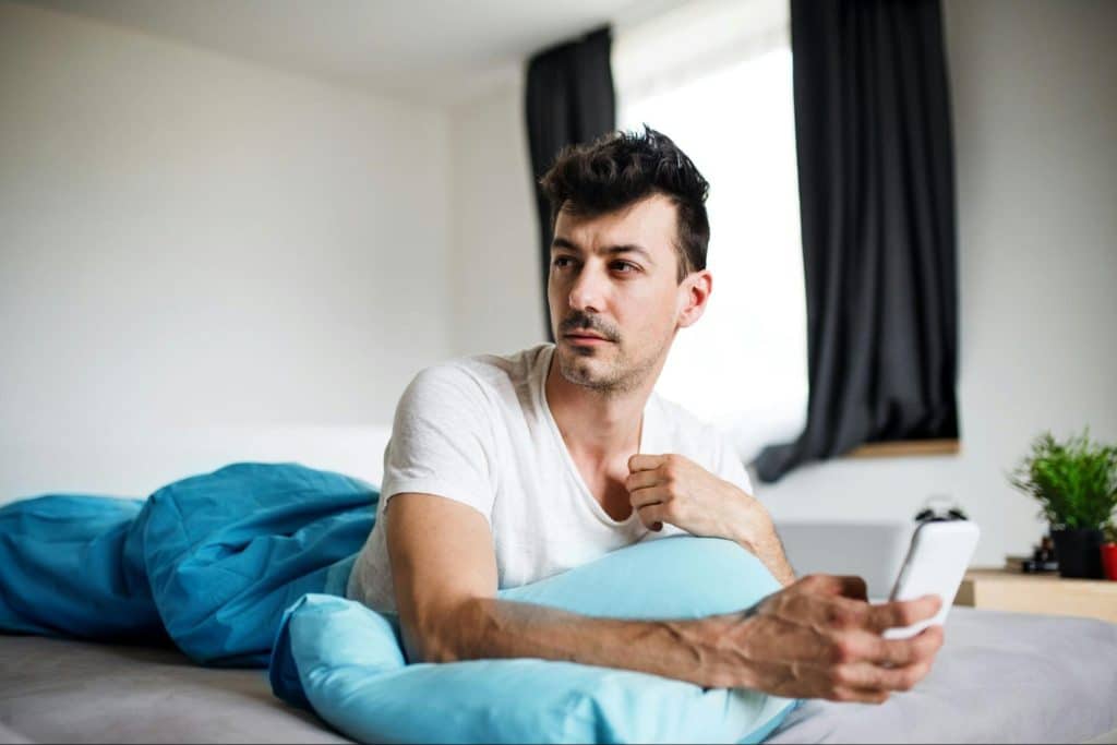 A man using a phone and worrying for something 